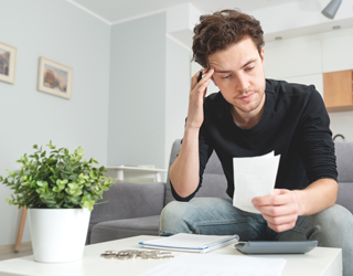 Man holding receipt, making financial revision
