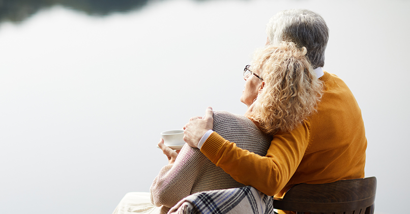 Dreamy senior couple relaxing on pier