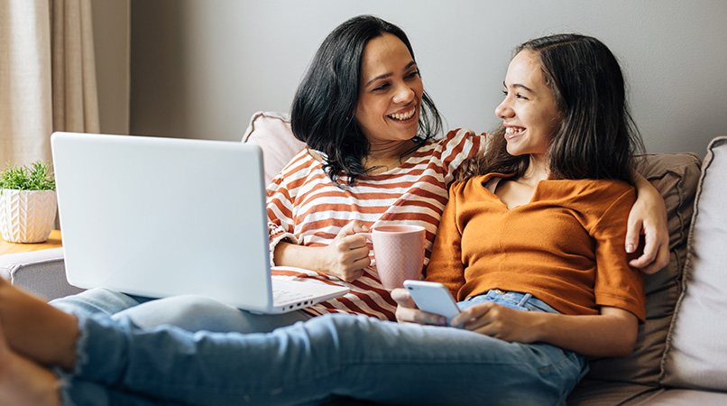 Single mother working from home with preteen daughter around